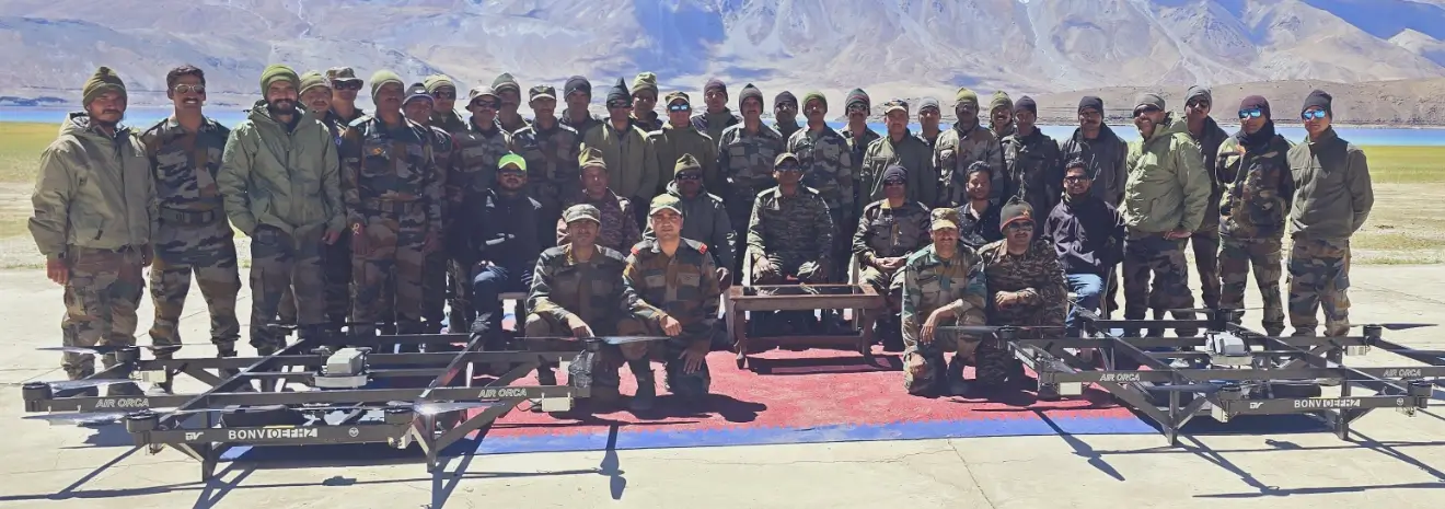 Group of soldiers standing in front of a mountainous landscape with clear blue sky